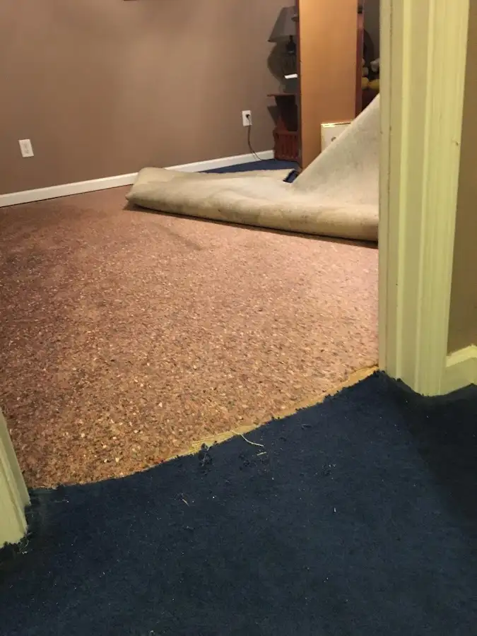 Carpet pad removal revealing water damage during Drying & Dehumidification in Spokane